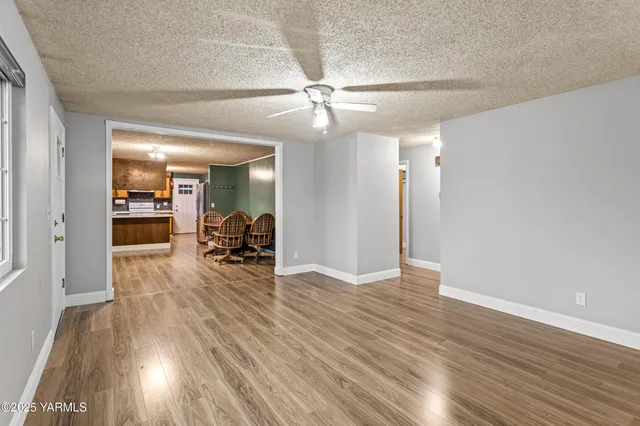 a view of a living room and hallway with wooden floor