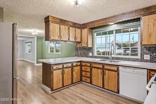 a kitchen with stainless steel appliances granite countertop a stove and a sink