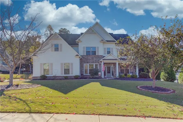 a view of a white house with a yard