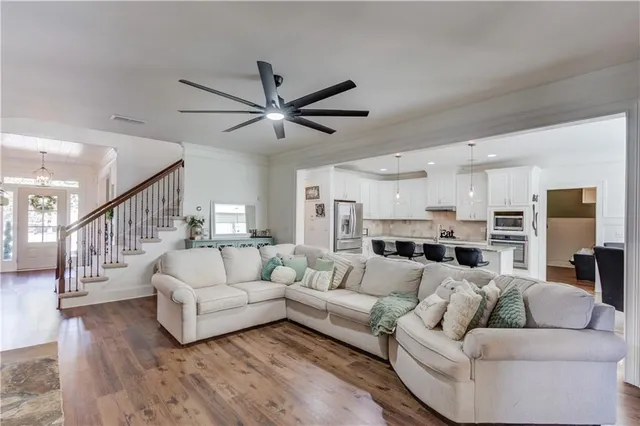 a kitchen with granite countertop a counter space a refrigerator and cabinets