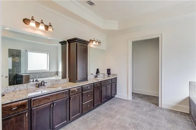 a bathroom with a shower a window and a sink