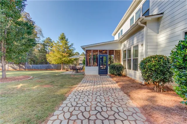a view of a house with backyard sitting area and garden