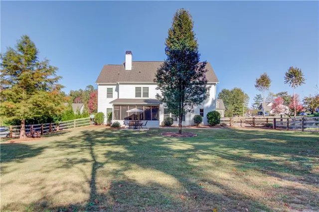 an aerial view of residential houses with yard