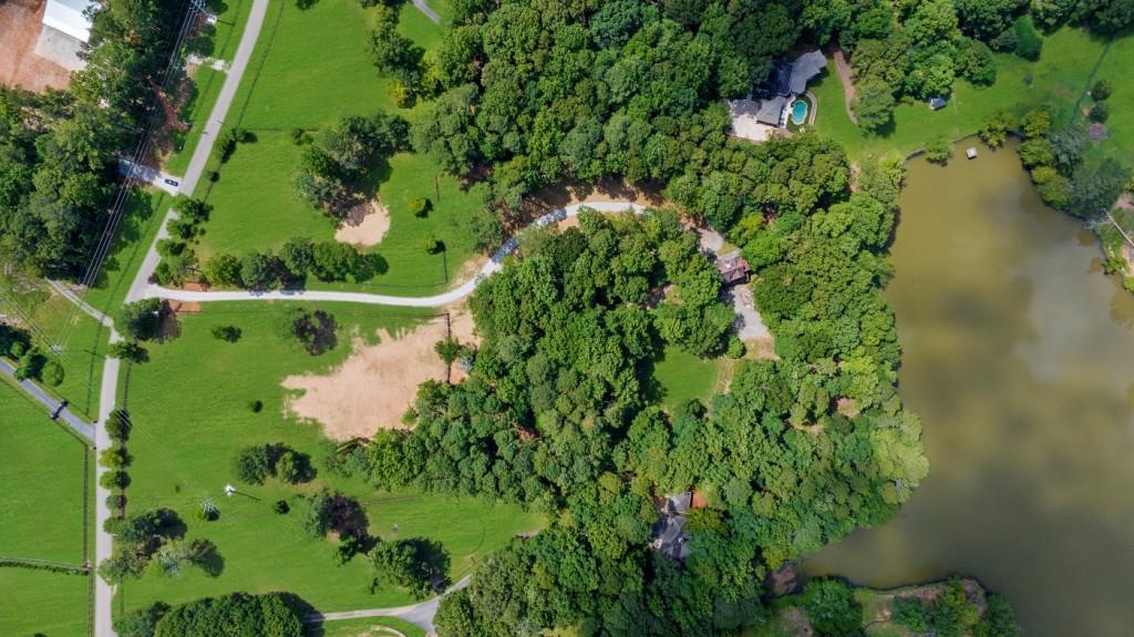 16280 Clarity Road Alpharetta, GA 30004 - Photo 8 of 13 a view of a garden with a lake