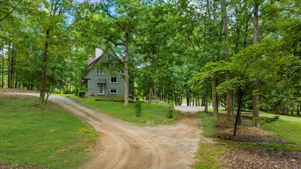 16280 Clarity Road Alpharetta, GA 30004 - Photo 10 of 13 a front view of a house with a yard and trees