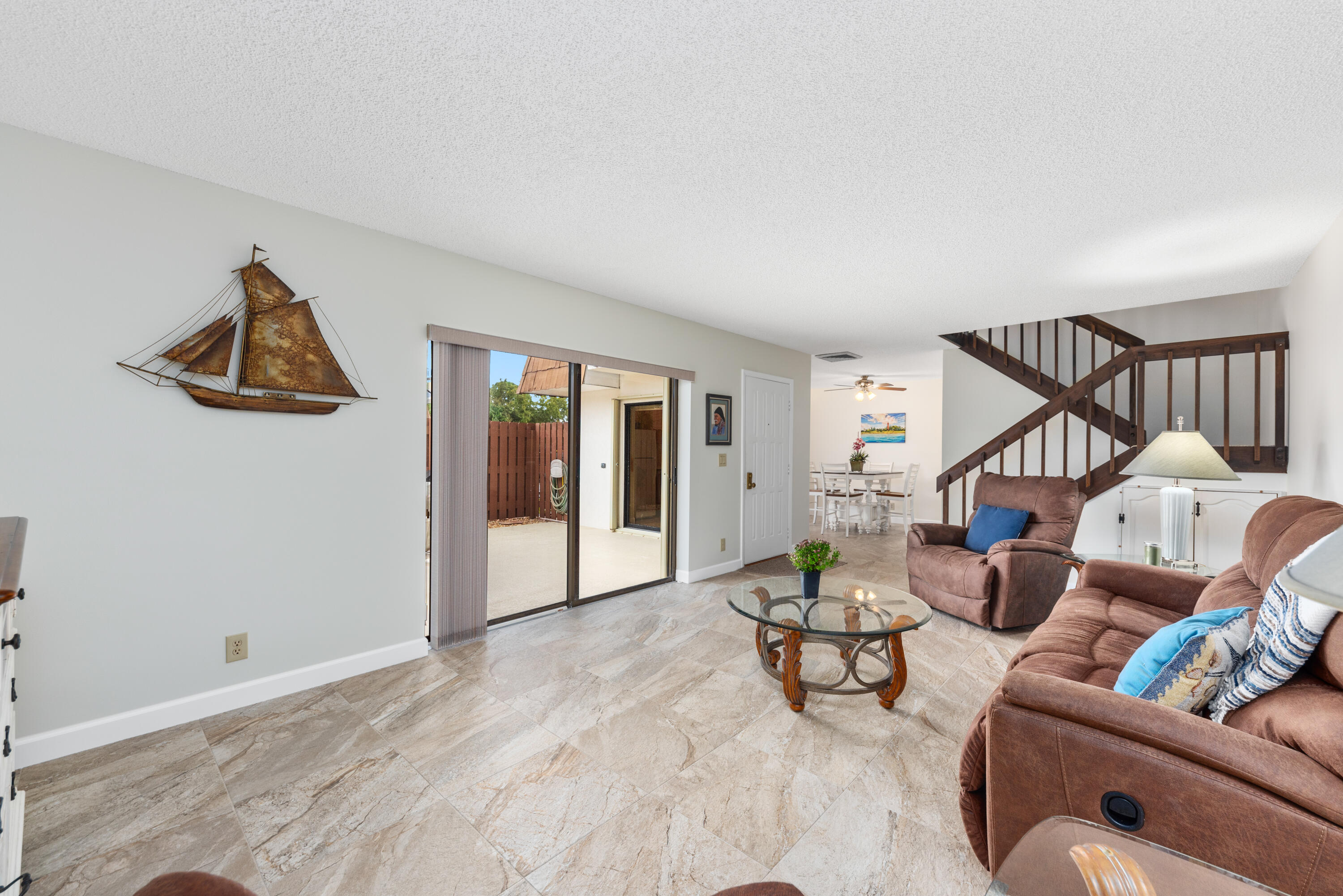 5874 Southeast Riverboat Drive, Unit 330 Stuart, FL 34997 - Photo 12 of 40 a living room with furniture and wooden floor
