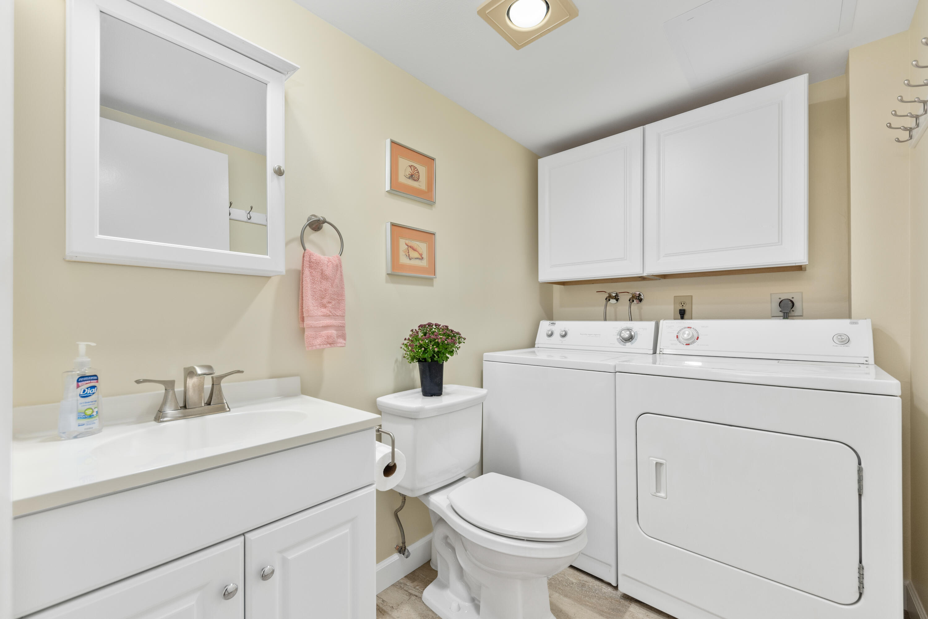 5874 Southeast Riverboat Drive, Unit 330 Stuart, FL 34997 - Photo 16 of 40 a bathroom with a sink toilet and a mirror