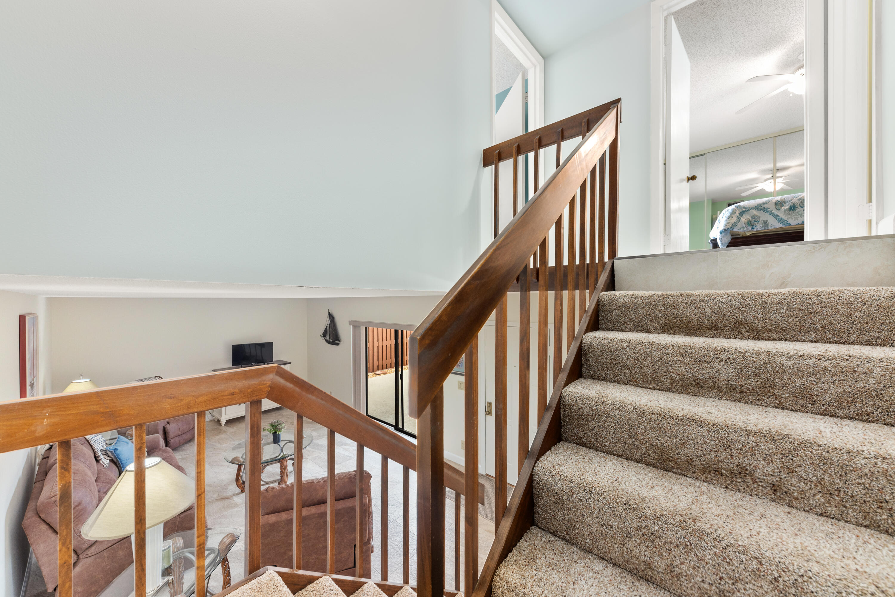 5874 Southeast Riverboat Drive, Unit 330 Stuart, FL 34997 - Photo 17 of 40 a view of staircase with lots of frames on wall and a large window