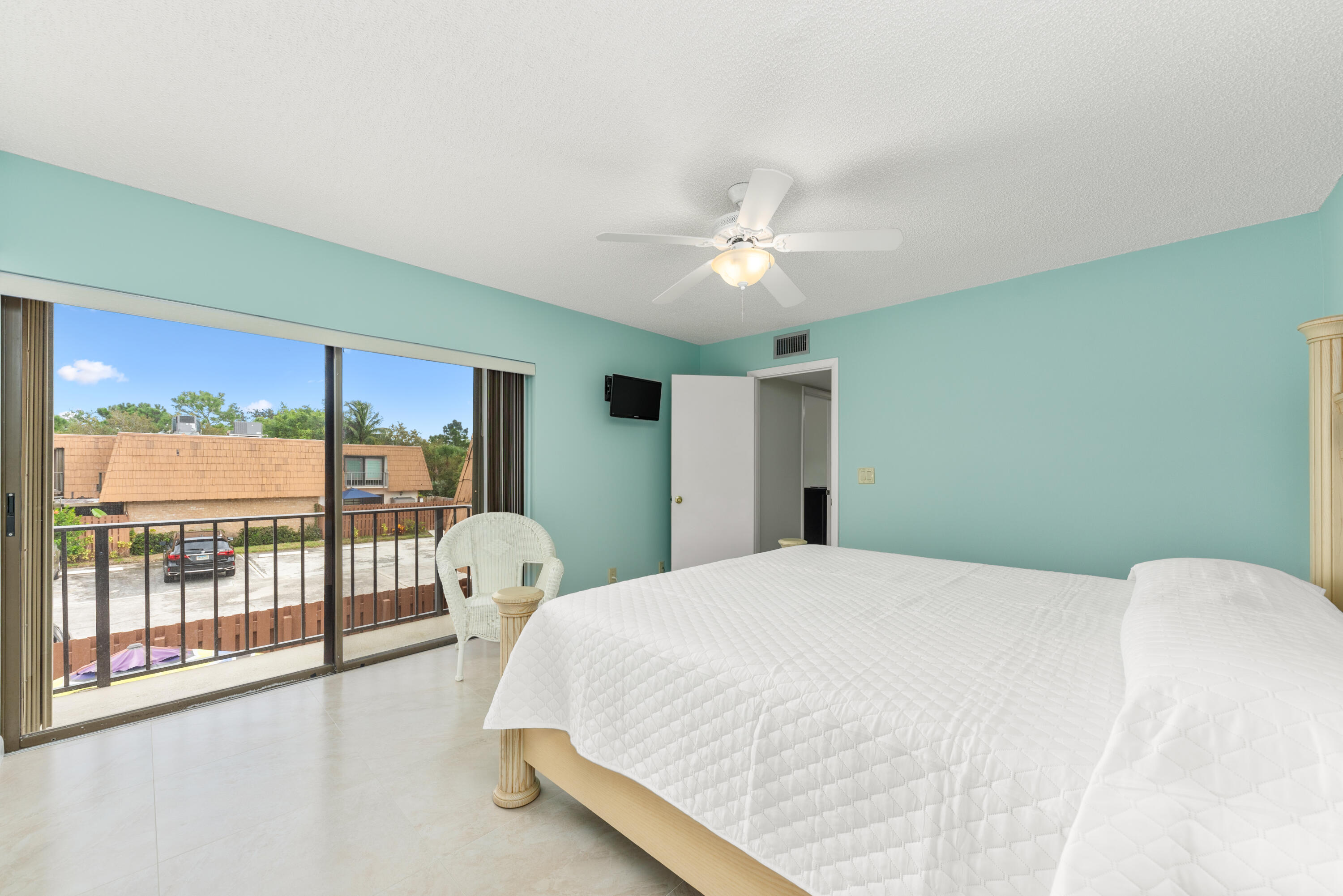 5874 Southeast Riverboat Drive, Unit 330 Stuart, FL 34997 - Photo 20 of 40 a bedroom with a large bed and a large window