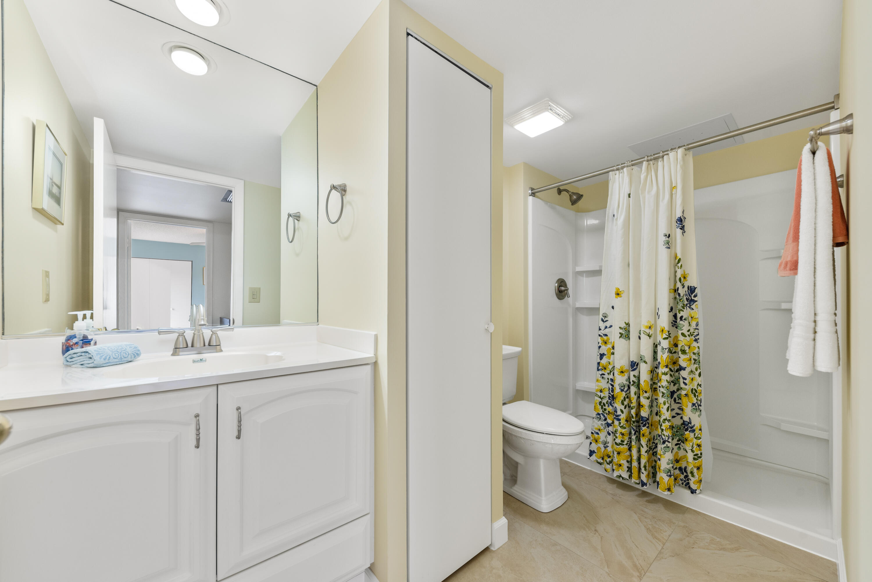 5874 Southeast Riverboat Drive, Unit 330 Stuart, FL 34997 - Photo 25 of 40 a bathroom with a double vanity sink toilet and shower