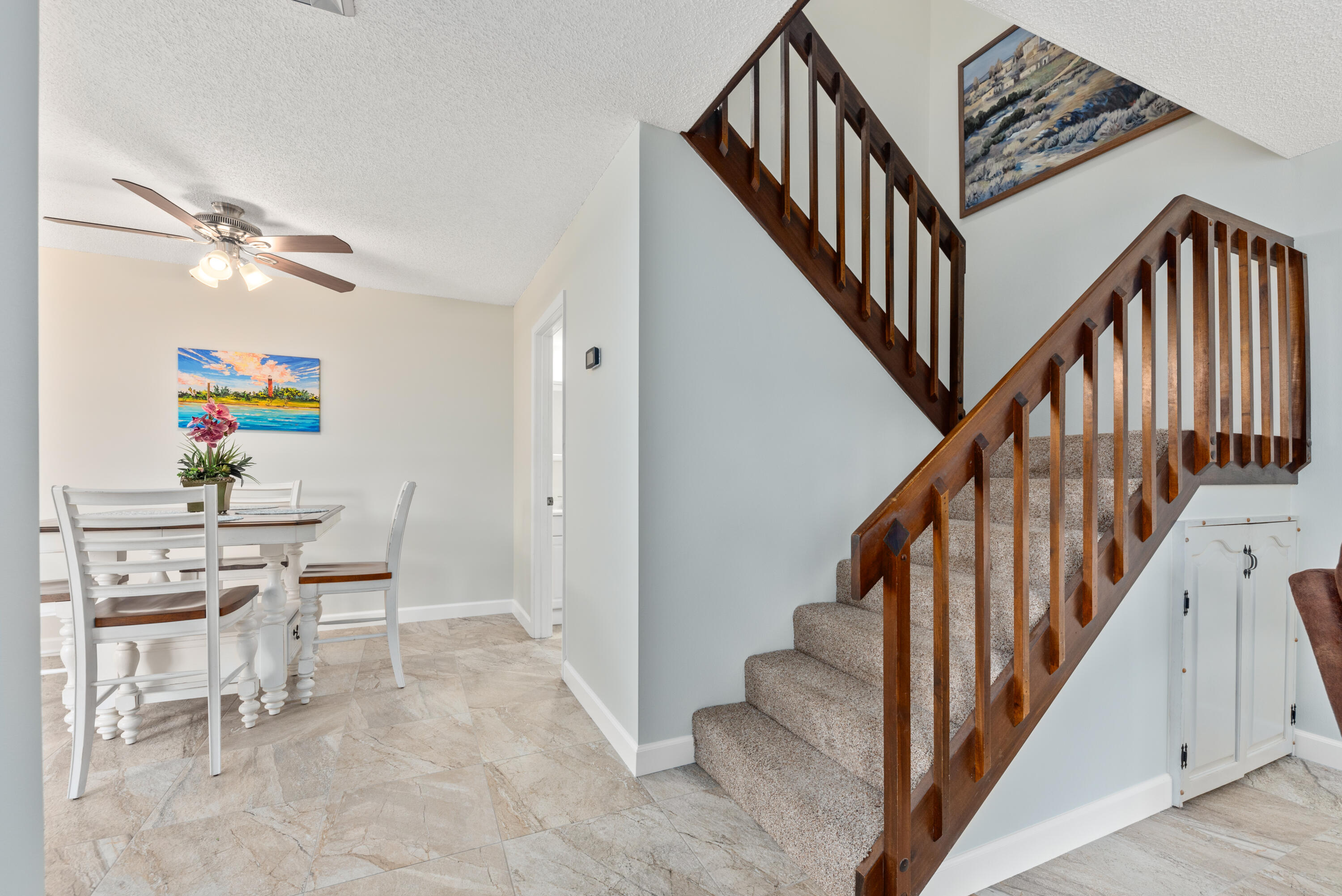 5874 Southeast Riverboat Drive, Unit 330 Stuart, FL 34997 - Photo 26 of 40 a dining room with furniture and a view of entryway