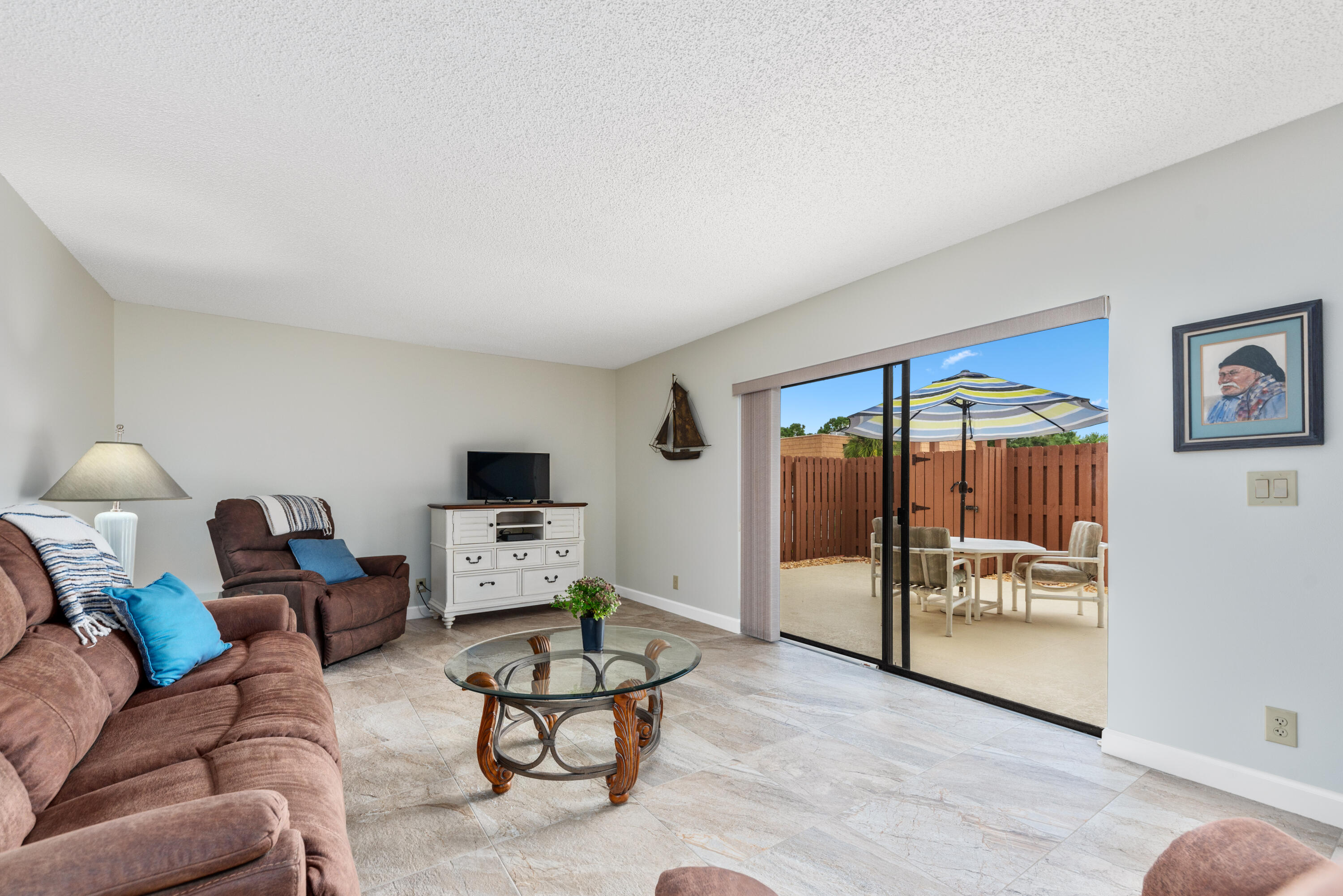 5874 Southeast Riverboat Drive, Unit 330 Stuart, FL 34997 - Photo 27 of 40 a living room with furniture and a flat screen tv
