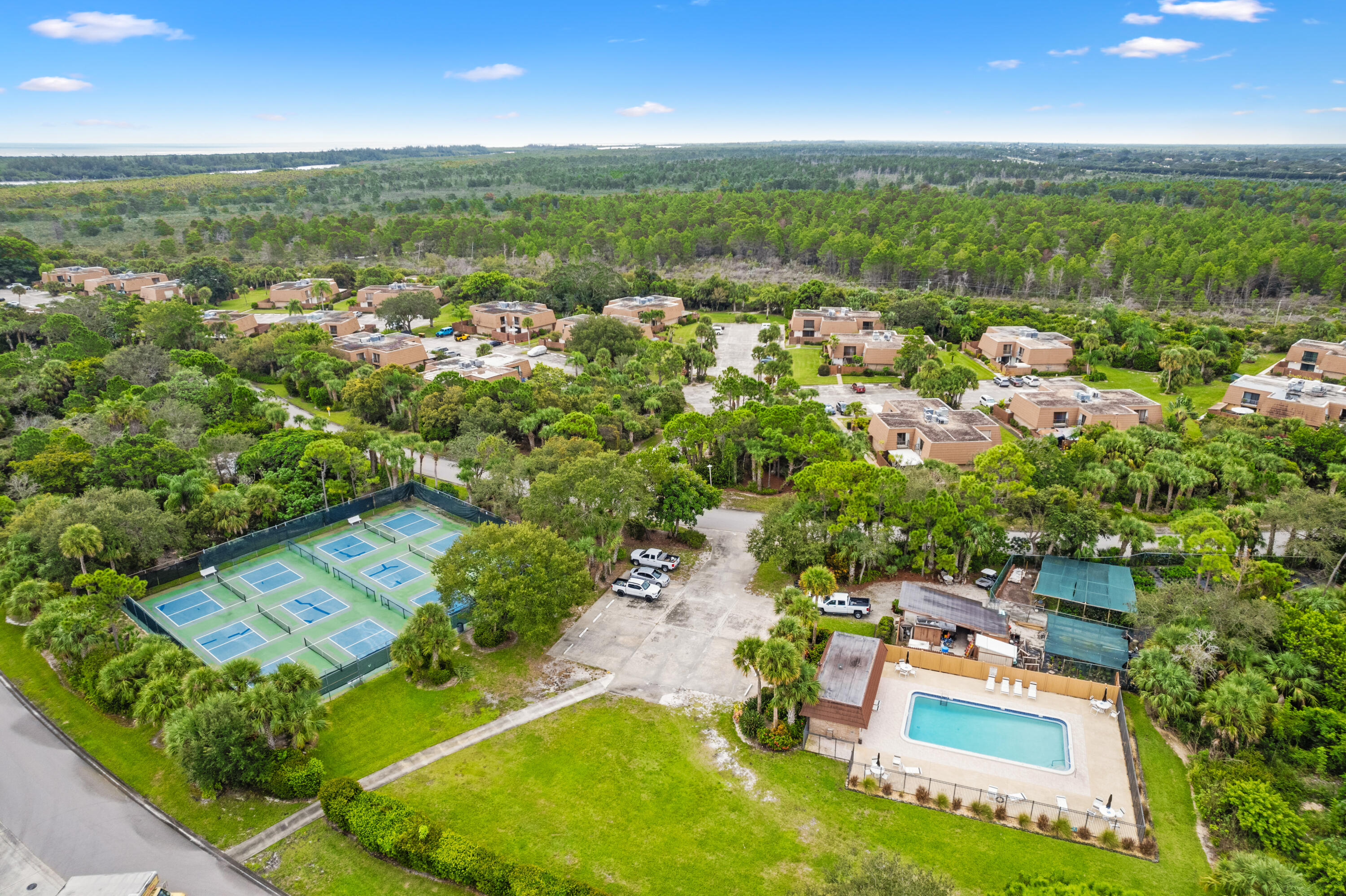 5874 Southeast Riverboat Drive, Unit 330 Stuart, FL 34997 - Photo 28 of 40 an aerial view of a house with a garden and swimming pool