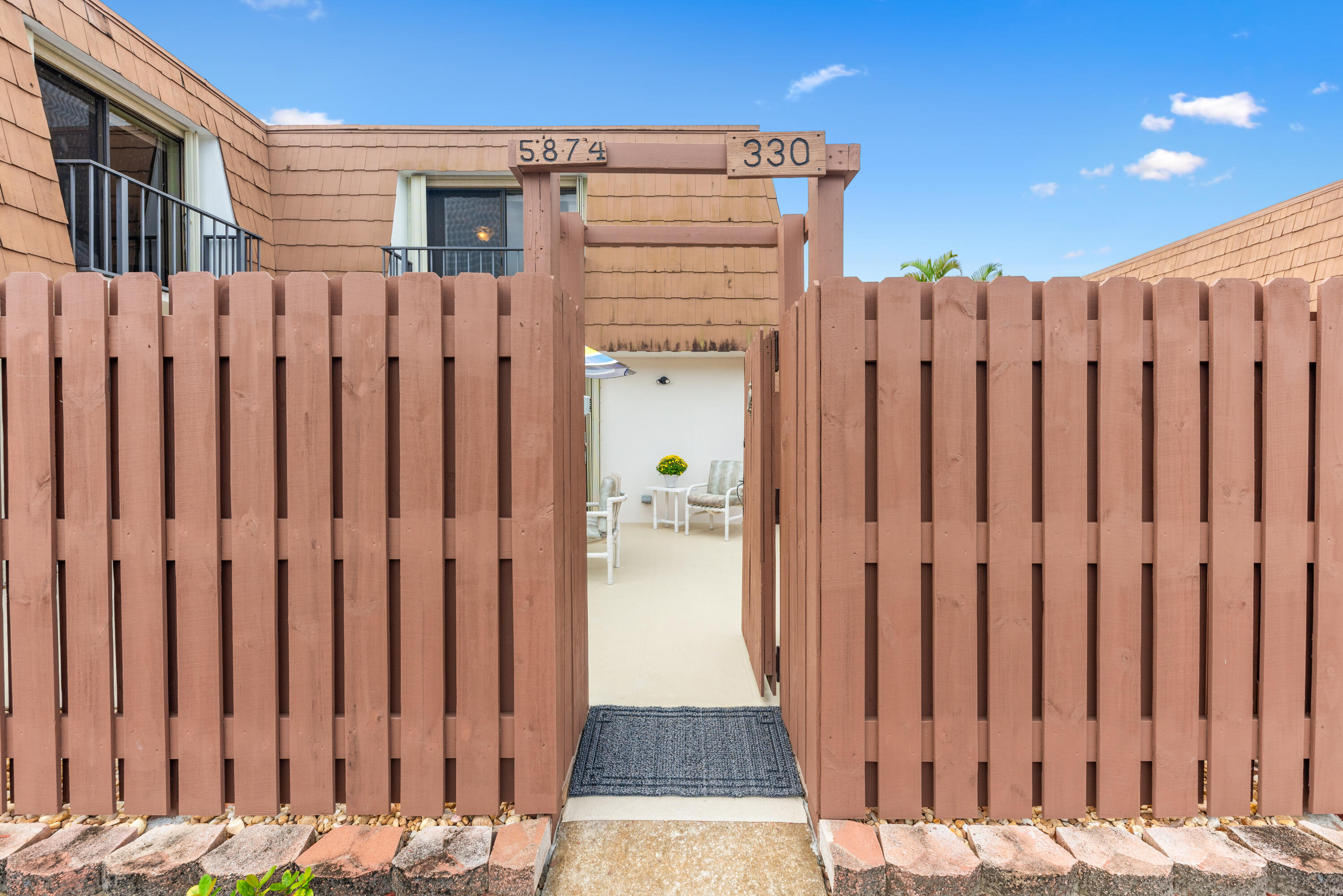 5874 Southeast Riverboat Drive, Unit 330 Stuart, FL 34997 - Photo 3 of 40 a view of a door with wooden fence
