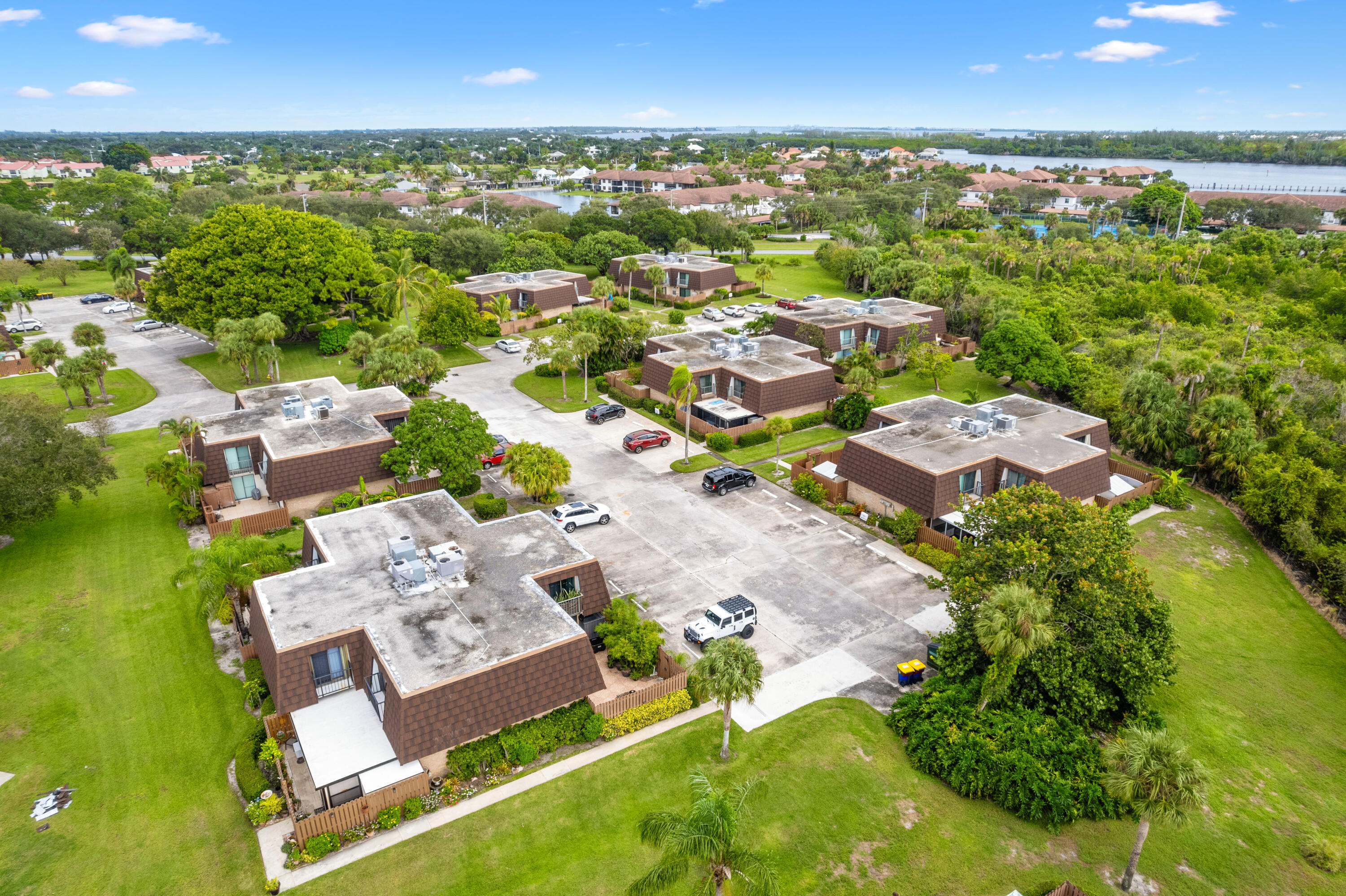 5874 Southeast Riverboat Drive, Unit 330 Stuart, FL 34997 - Photo 38 of 40 an aerial view of residential houses with outdoor space and trees