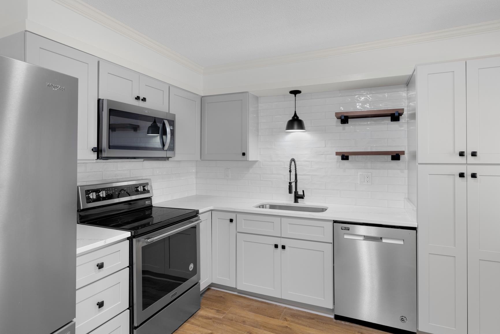 426 Homeville Road Collierville, TN 38017 - Photo 15 of 23 a kitchen with white cabinets and stainless steel appliances
