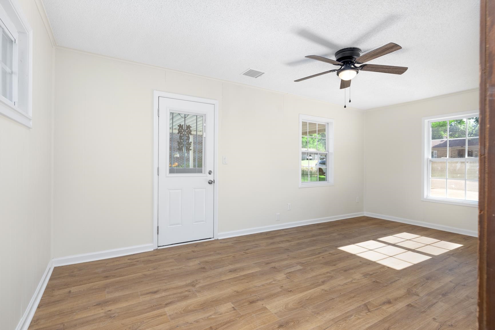 426 Homeville Road Collierville, TN 38017 - Photo 8 of 23 a view of empty room with wooden floor and fan