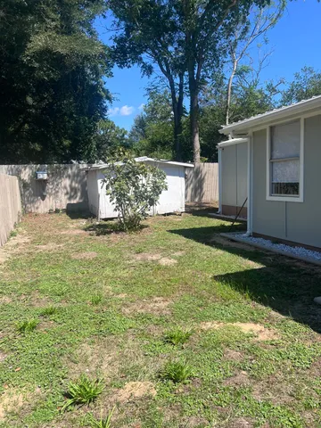 a view of a backyard with large trees