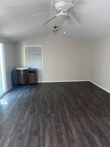 a view of a room with wooden floor and cabinet