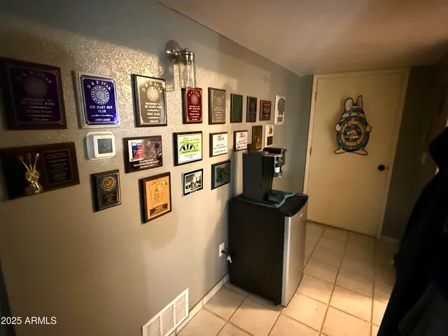 a view of a kitchen with fridge and workspace