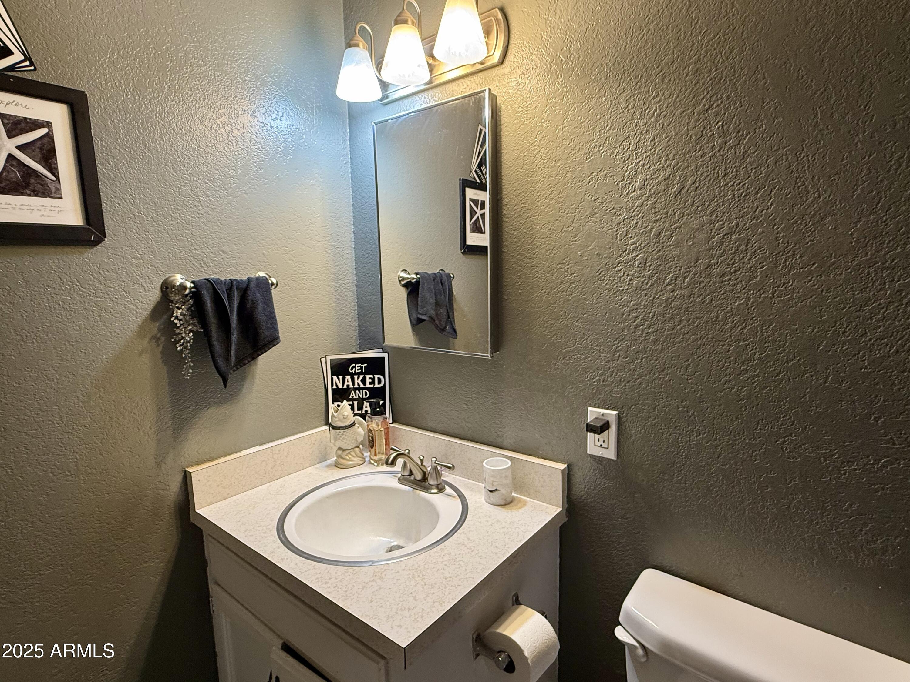 2535 East Roadrunner Ridge Tombstone, AZ 85638 - Photo 14 of 20 a bathroom with a sink and a mirror