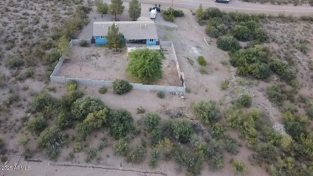 an aerial view of a house with a yard