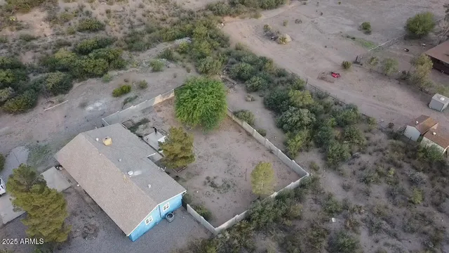 an aerial view of a house with a yard