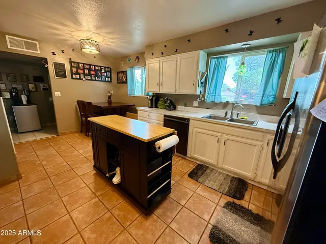 a kitchen with a sink appliances and cabinets