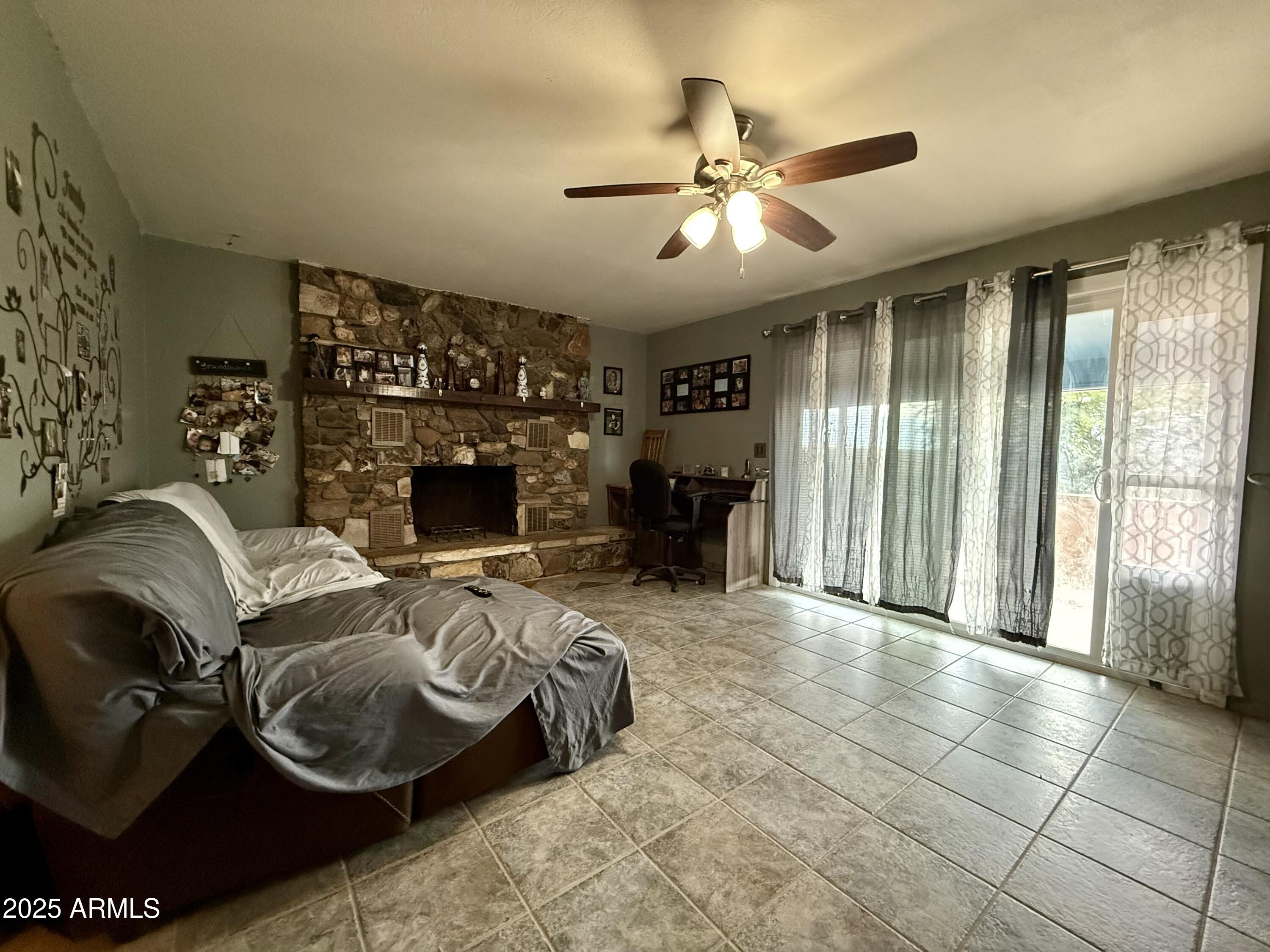 2535 East Roadrunner Ridge Tombstone, AZ 85638 - Photo 9 of 20 a living room with furniture and a fireplace