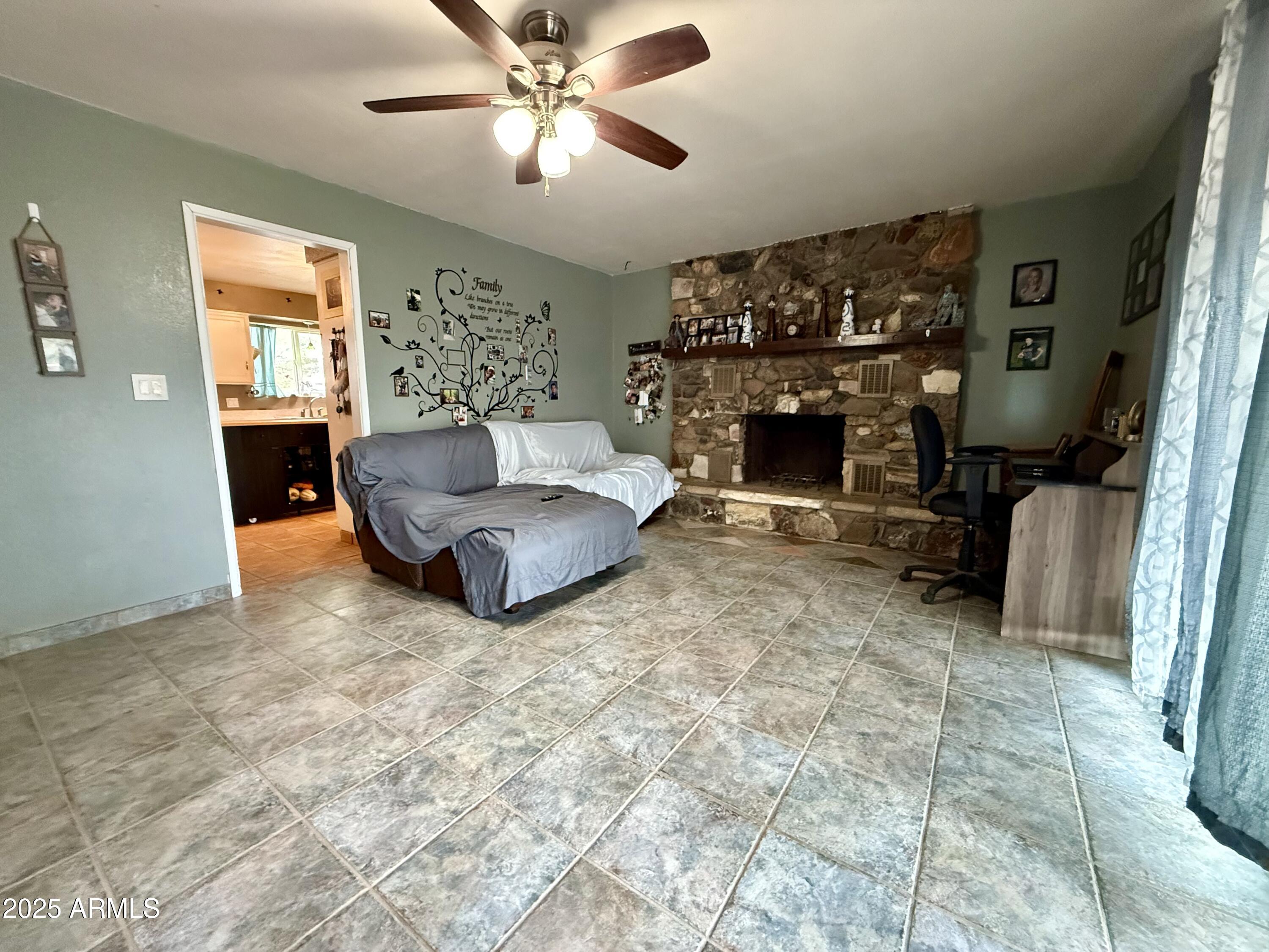 2535 East Roadrunner Ridge Tombstone, AZ 85638 - Photo 10 of 20 a living room with furniture and a fireplace