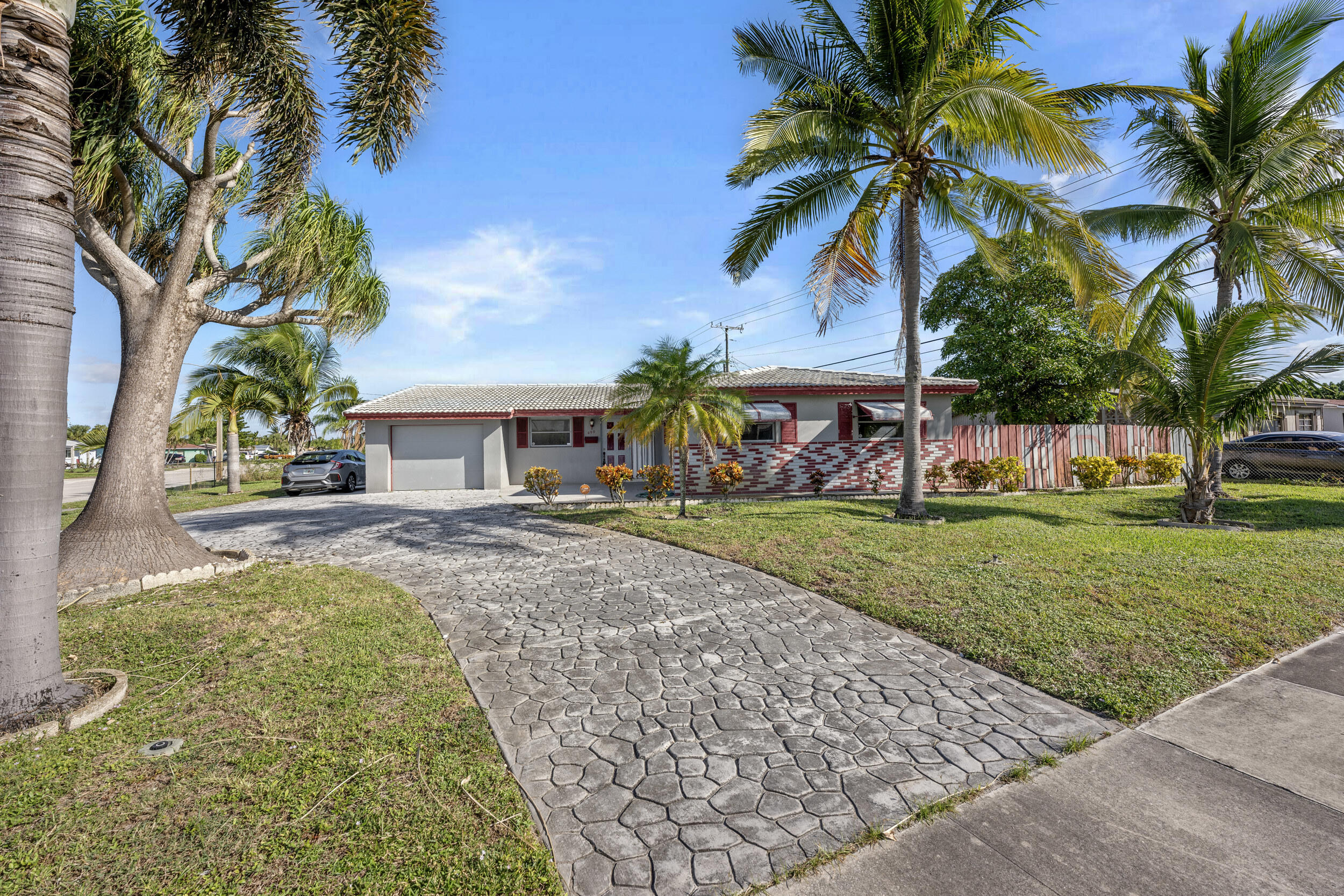 490 West 31st Street Riviera Beach, FL 33404 - Photo 1 of 29 a front view of a house with garden