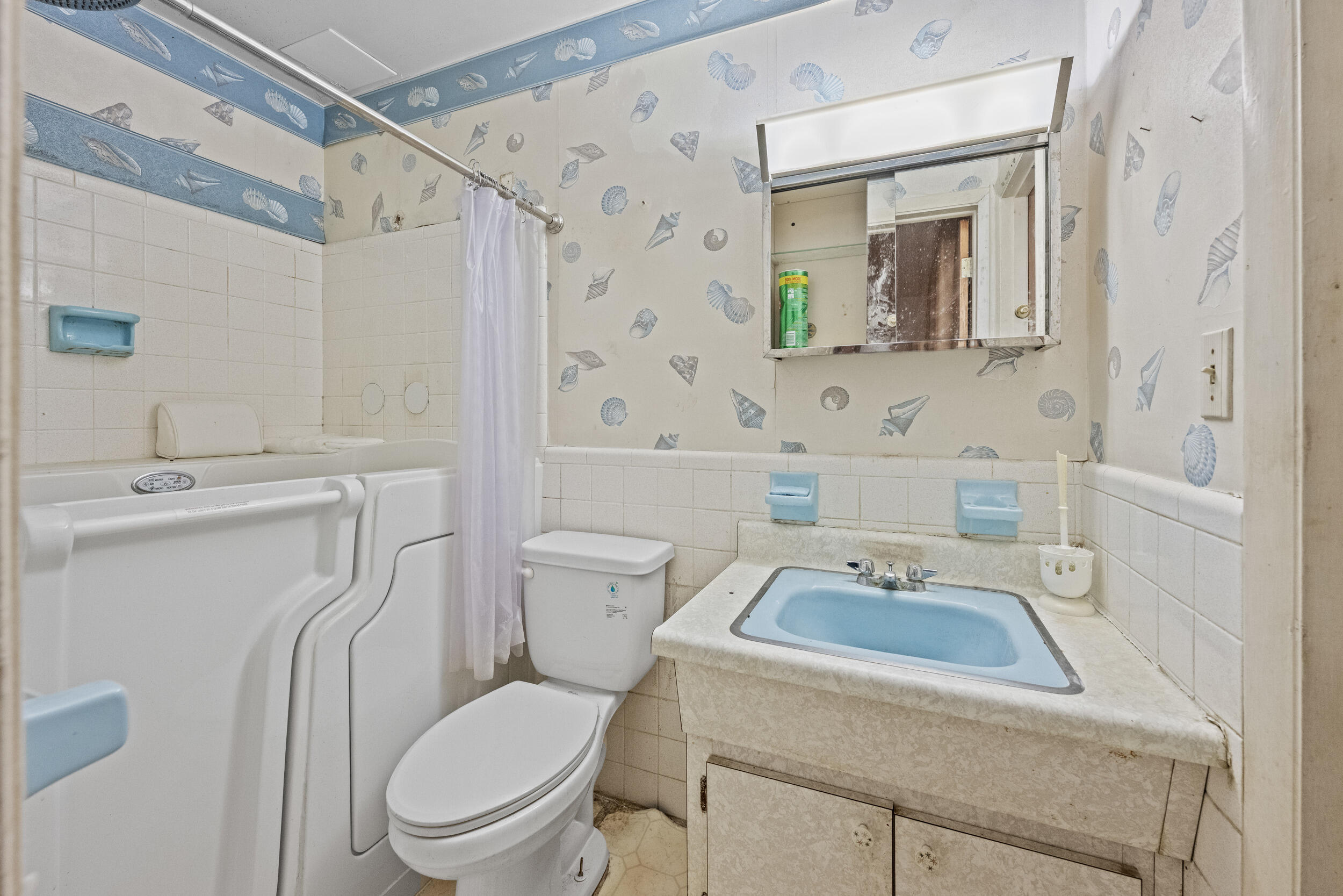 490 West 31st Street Riviera Beach, FL 33404 - Photo 14 of 29 a white toilet sitting next to a bathroom sink