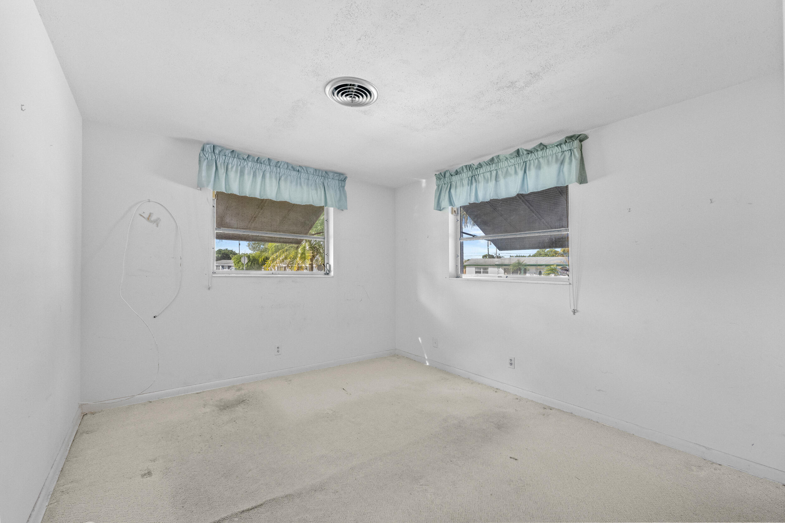 490 West 31st Street Riviera Beach, FL 33404 - Photo 15 of 29 an empty room with windows and painted walls