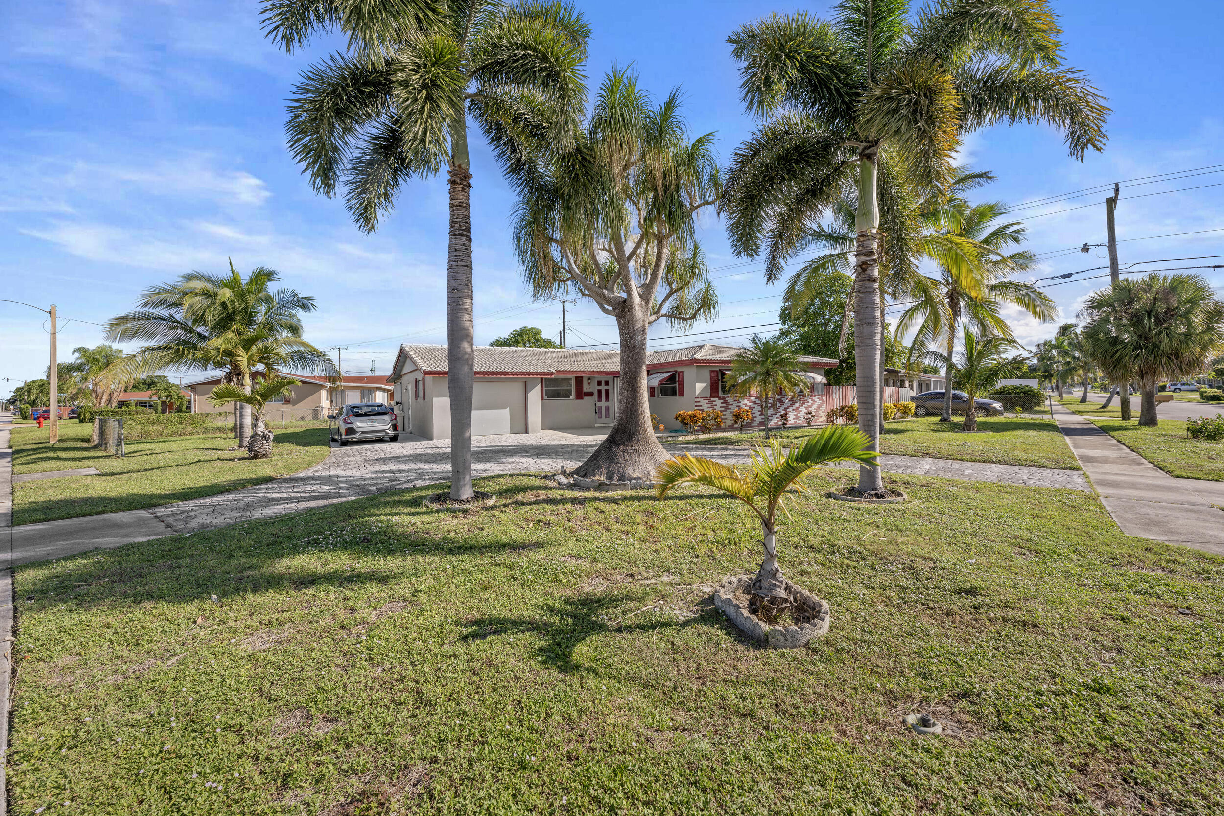 490 West 31st Street Riviera Beach, FL 33404 - Photo 3 of 29 a swimming pool with yard and outdoor seating