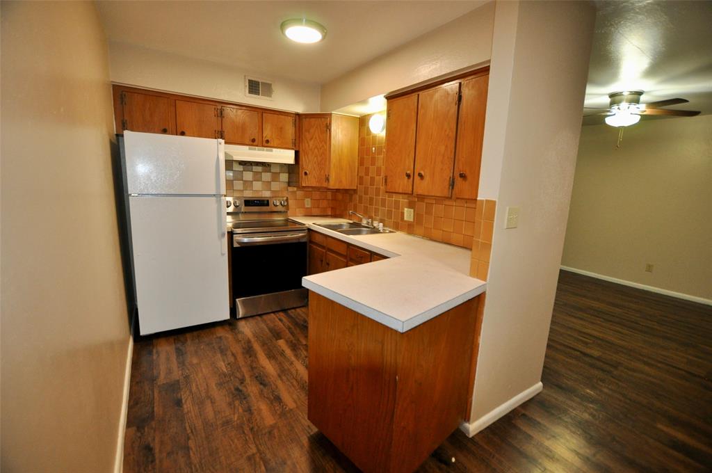 202 East Oak Street, Unit 12 Weatherford, TX 76086 - Photo 4 of 8 a kitchen with a refrigerator sink and stove