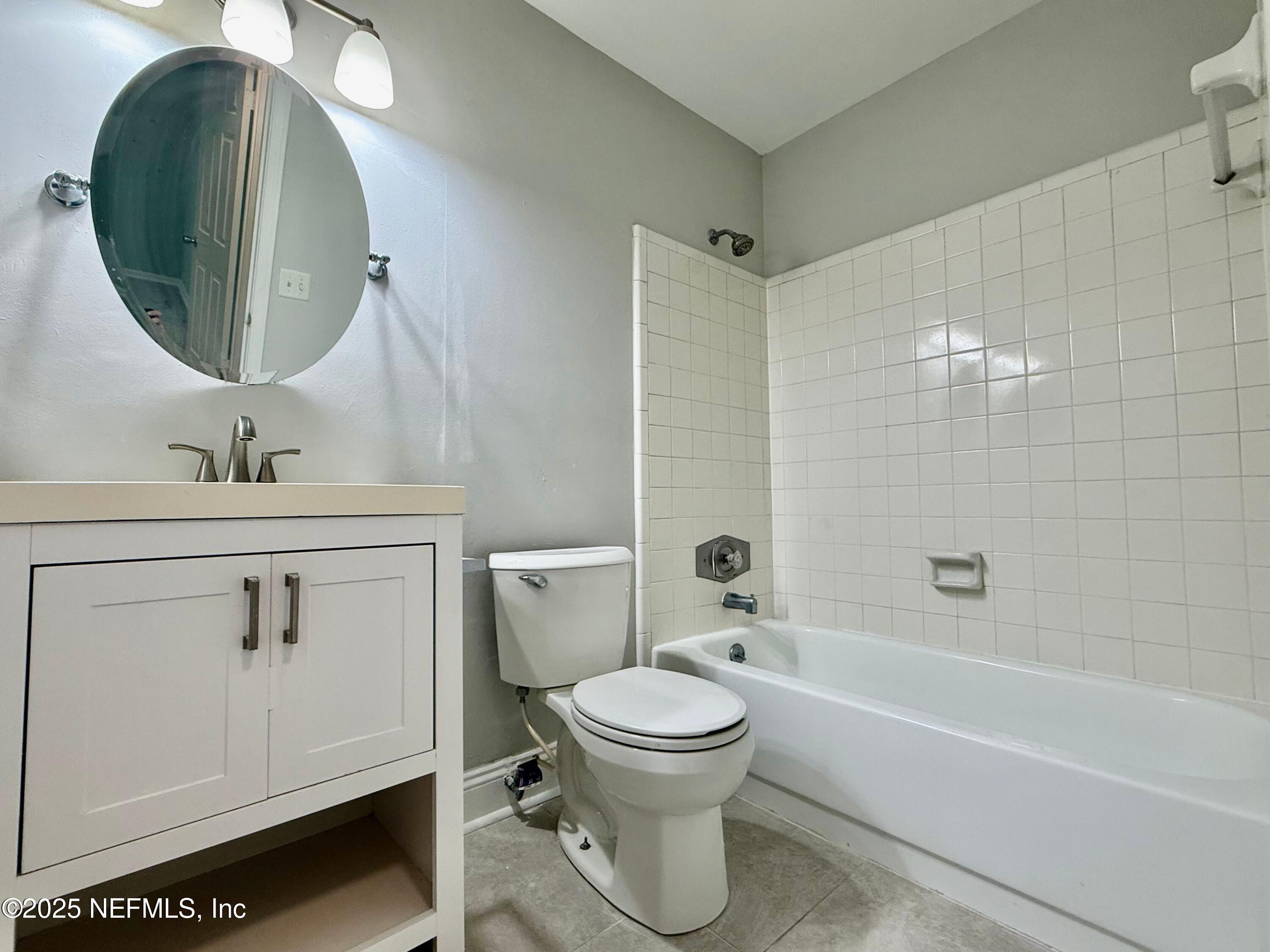 3801 Crown Point Road, Unit 1074 Jacksonville, FL 32257 - Photo 11 of 22 a bathroom with a toilet sink and mirror