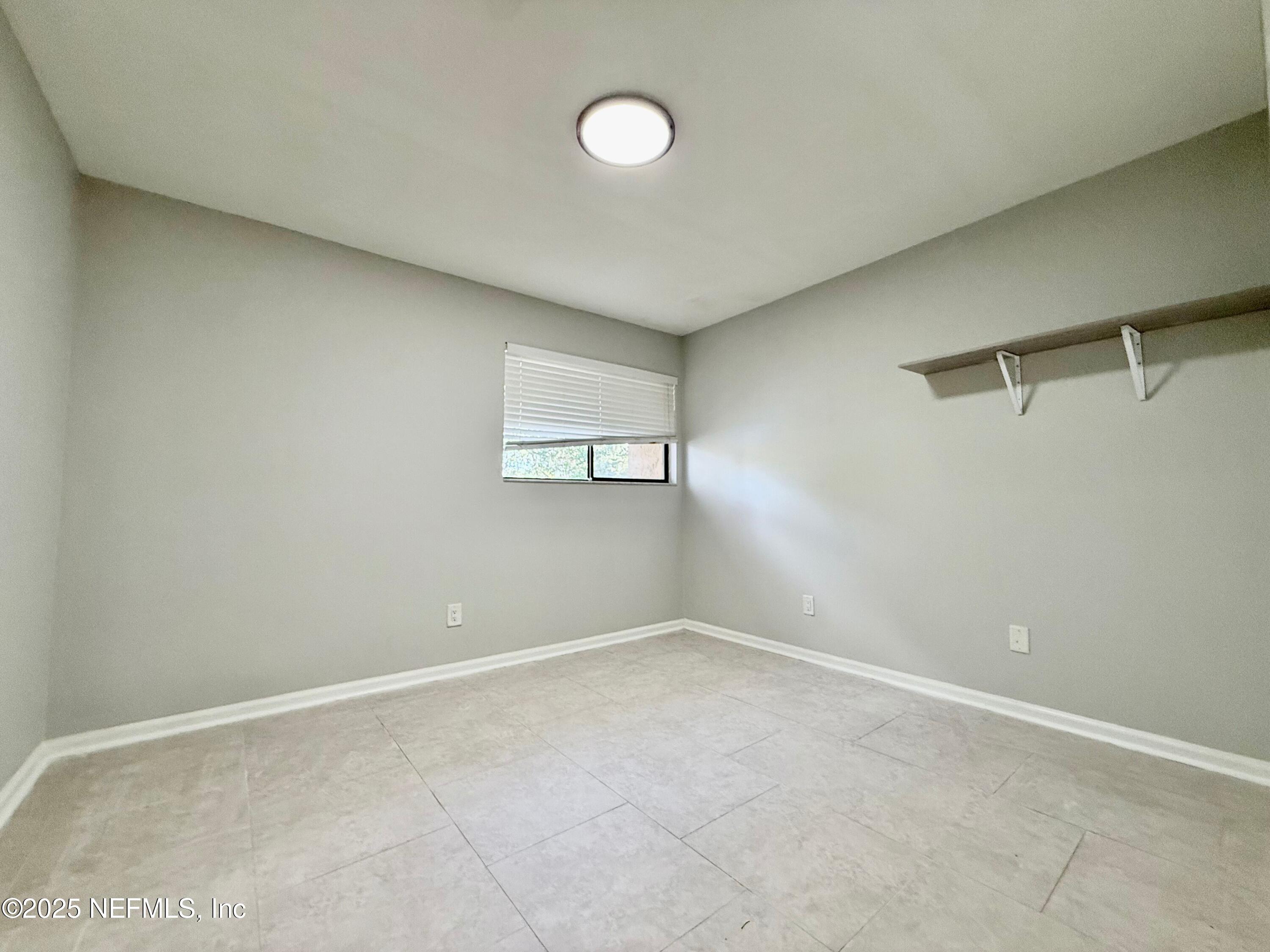 3801 Crown Point Road, Unit 1074 Jacksonville, FL 32257 - Photo 12 of 22 a view of an empty room with a window