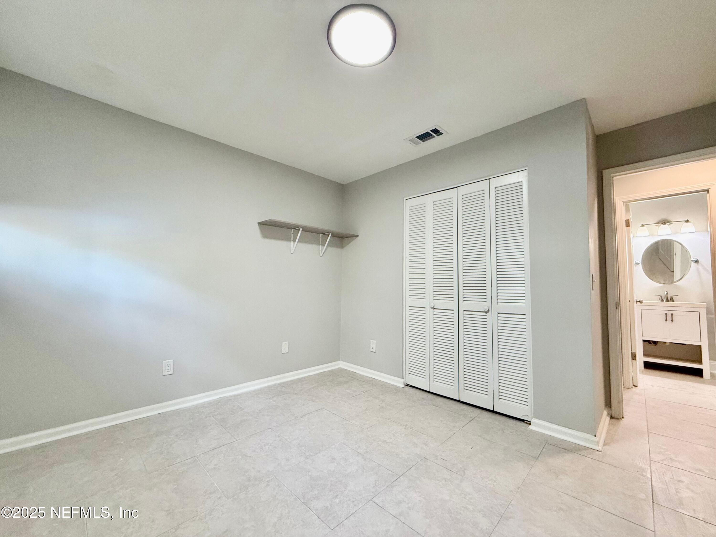 3801 Crown Point Road, Unit 1074 Jacksonville, FL 32257 - Photo 13 of 22 an empty room with closet
