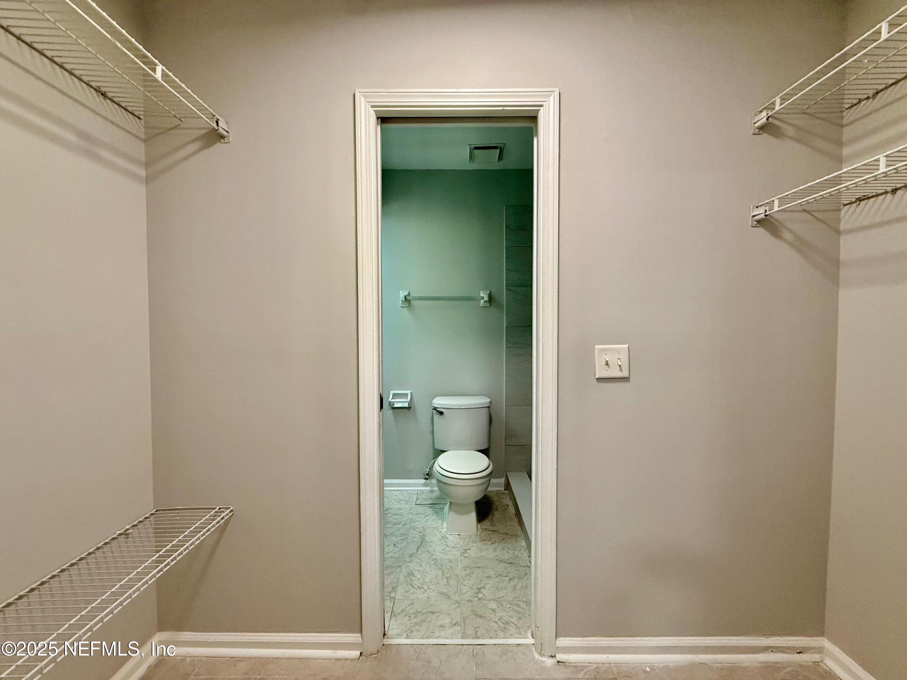 3801 Crown Point Road, Unit 1074 Jacksonville, FL 32257 - Photo 15 of 22 a bathroom with a granite countertop toilet and a shower