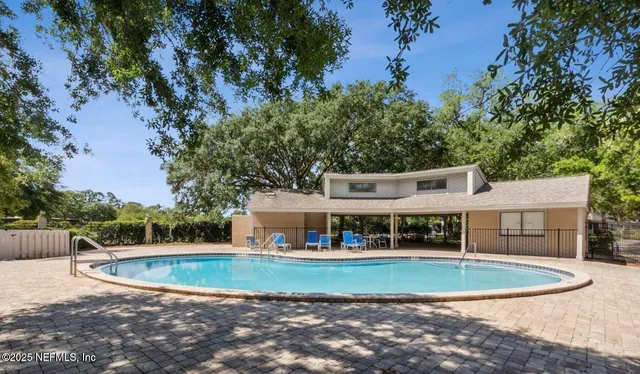 a view of house with outdoor space and swimming pool