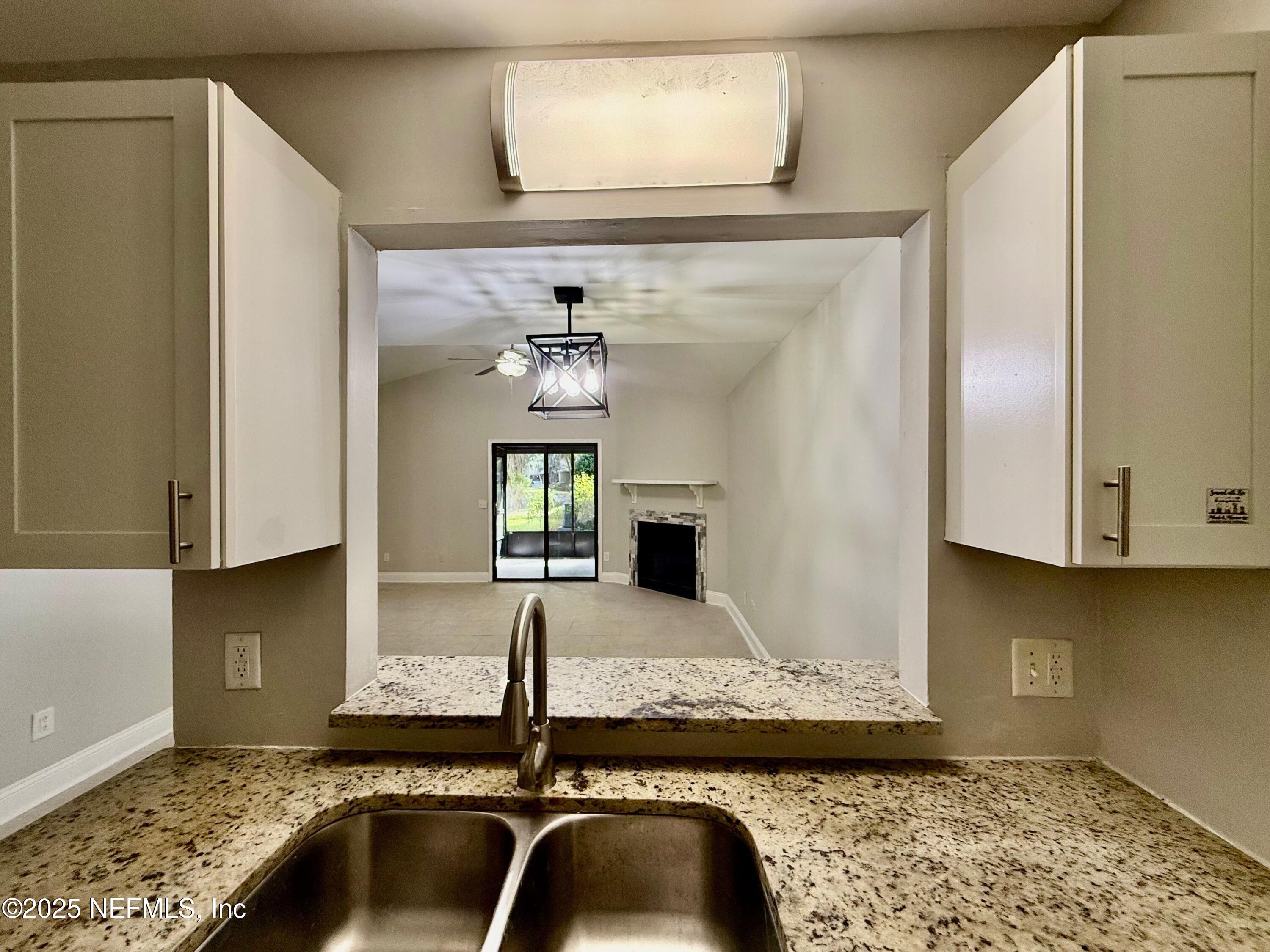 3801 Crown Point Road, Unit 1074 Jacksonville, FL 32257 - Photo 9 of 22 a kitchen with a granite countertop sink and stove