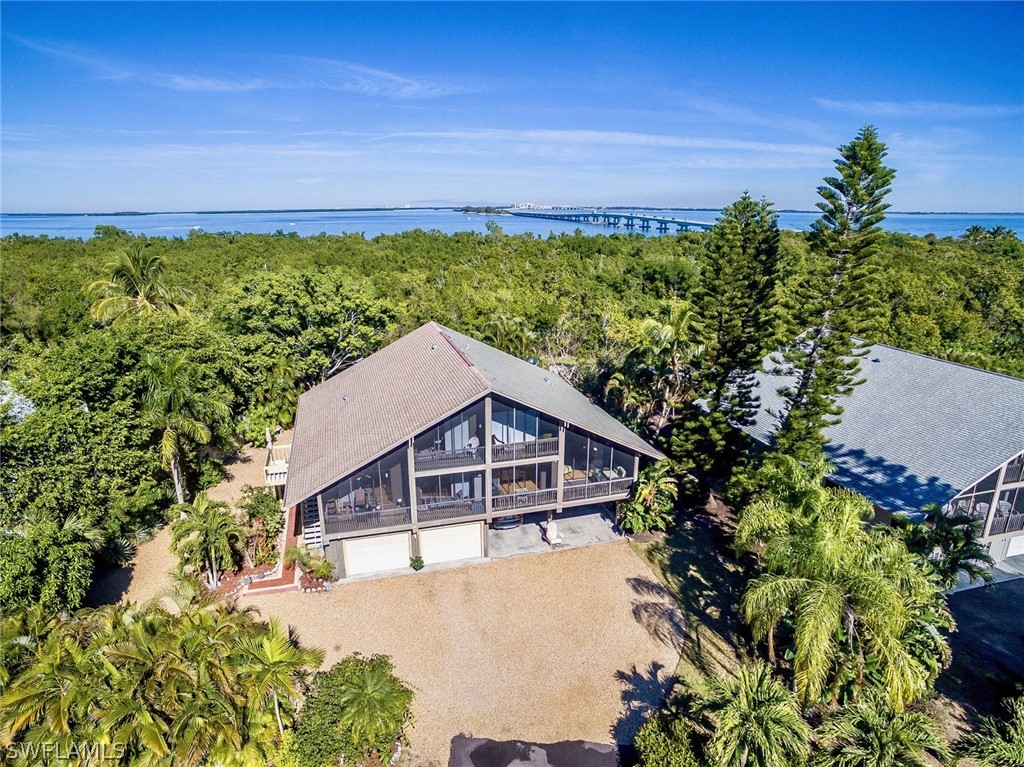 974 Sand Castle Road Sanibel, FL 33957 - Photo 1 of 31 a house with trees in the background