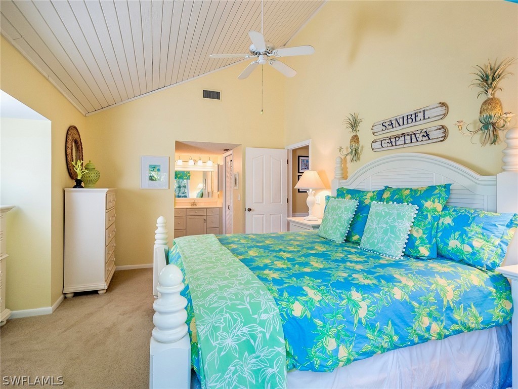 974 Sand Castle Road Sanibel, FL 33957 - Photo 12 of 31 a bedroom with a bed and a table