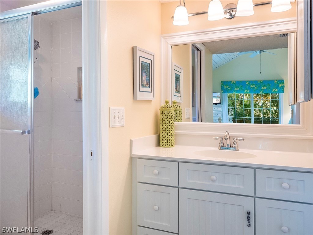 974 Sand Castle Road Sanibel, FL 33957 - Photo 14 of 31 a bathroom with a granite countertop sink and a mirror