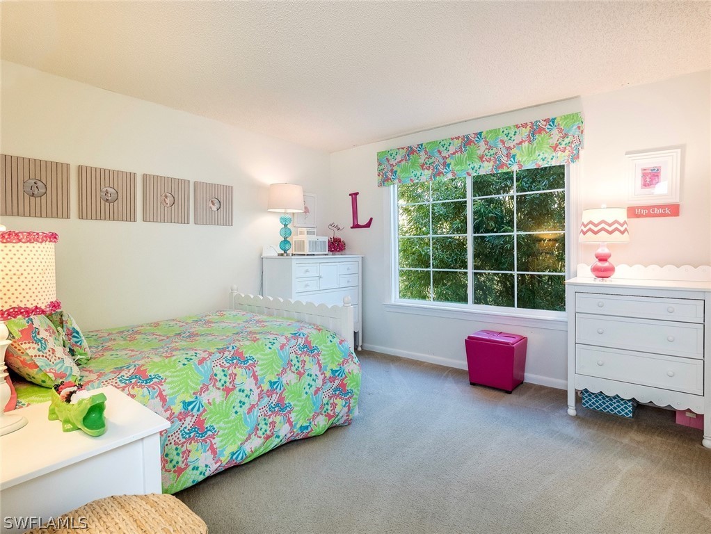 974 Sand Castle Road Sanibel, FL 33957 - Photo 15 of 31 a bedroom with bed and a window