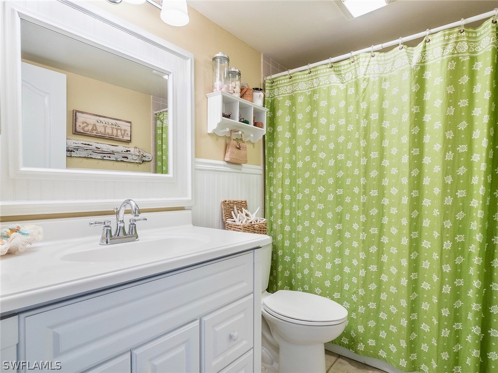 974 Sand Castle Road Sanibel, FL 33957 - Photo 16 of 31 a bathroom with a sink a toilet and a mirror