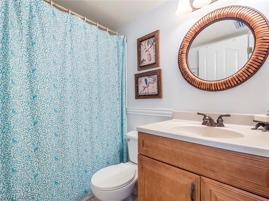 974 Sand Castle Road Sanibel, FL 33957 - Photo 19 of 31 a bathroom with a sink a toilet and a mirror