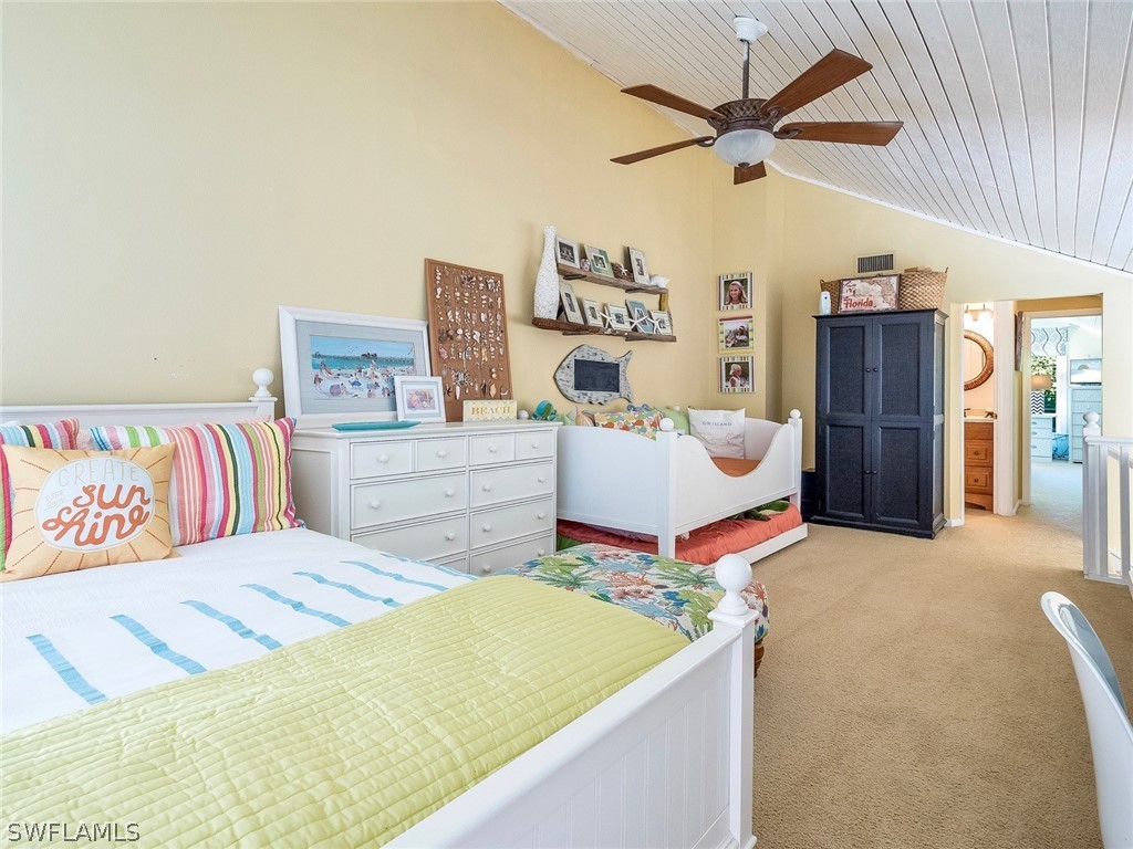 974 Sand Castle Road Sanibel, FL 33957 - Photo 20 of 31 a bedroom with a bed and a chandelier
