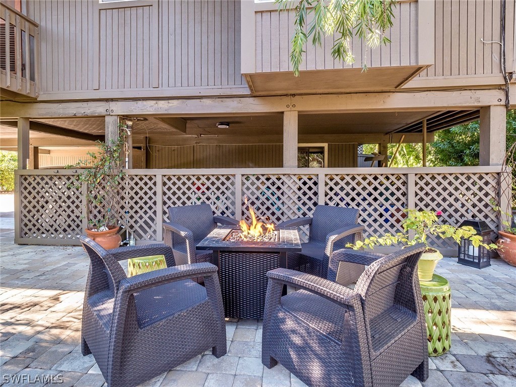 974 Sand Castle Road Sanibel, FL 33957 - Photo 23 of 31 a backyard of a house with chairs