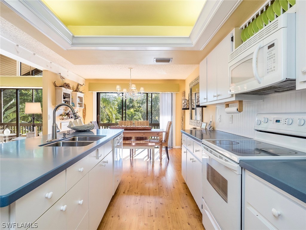 974 Sand Castle Road Sanibel, FL 33957 - Photo 9 of 31 a kitchen with stainless steel appliances granite countertop a stove a sink and cabinets
